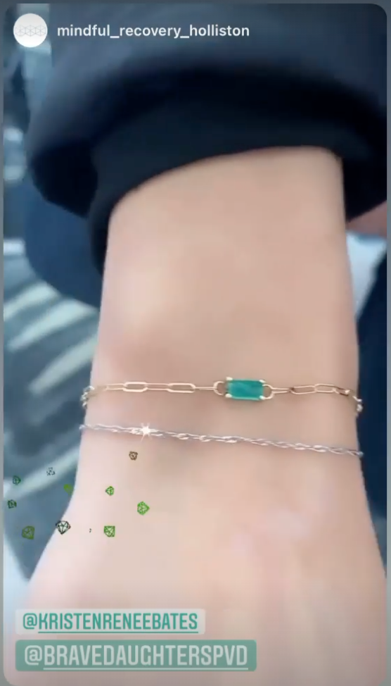 Screenshot of an instagram story showing a woman wearing two bracelets with the tags of the account of the person wearing the jewelry and the jewelry business she bought them from.